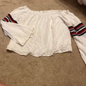Off the shout white blouse with blue and red striping on the arms.